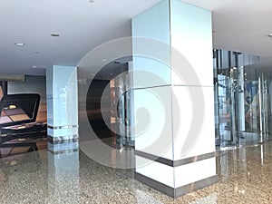 Columns with transparent glass cladding and stainless steel skirting with Gypsum false ceiling interiors