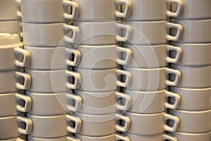 Columns of white tea and coffee mugs in the hotel restaurant photo