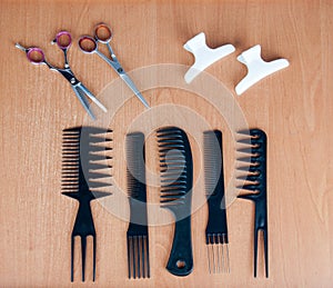 Comb brushes, scissors and hairspins on the table