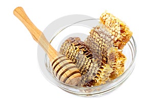 Comb honey in a bowl glass on white background.