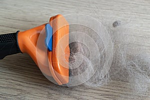 The comb of pet slicker brush with cat fur clump after grooming