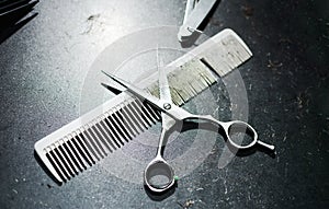 Comb and scissors on a dirty table