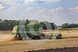 Combain harvester mows wheat
