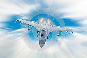 Combat fighter jet on a military mission with weapons - rockets, bombs, weapons on wings, at high speed with fire afterburner engi