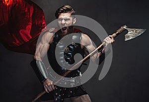 Combat greek warrior screaming and posing in dark background