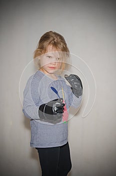 In combat rack, child, girl in gloves for hand-to-hand combat