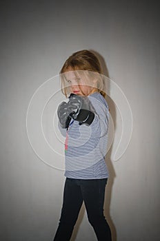 In combat rack, child, girl in gloves for hand-to-hand combat