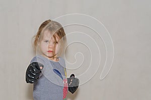 In combat rack, child, girl in gloves for hand-to-hand combat