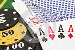 Combination of four aces on the background of a deck of cards and poker chips