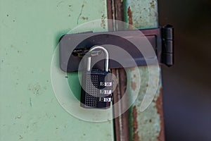 combination lock fastened a old rusty door with style
