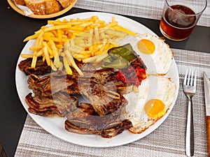 Combination meal with churrasco, fried eggs, french fries and peppers