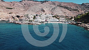 Combination of natural Greek landscape and touristic build-up village. Finika Beach in Loutro seen from aerial