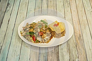 Combination plate of chicken with noodles and vegetables, chaufa rice photo