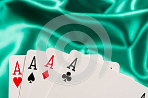 The combination of playing cards poker  casino. Four aces on green background