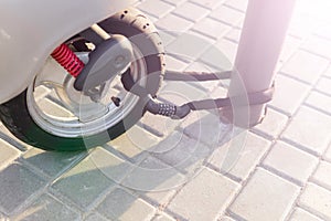 Combination security lock blocking the  motor scooter wheel