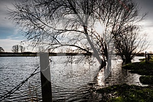 Heavily flooded fields by a riverbank, seen after severe storms within the UK. photo