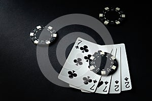 A combination of two pairs of playing cards and chips on a black table in a poker club. Winning at a casino depends on luck.