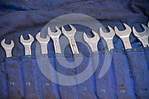 Combination wrenches with rings and open ends