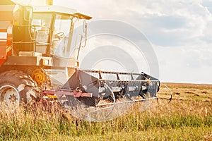 Combine harvester agriculture machine working in field close up