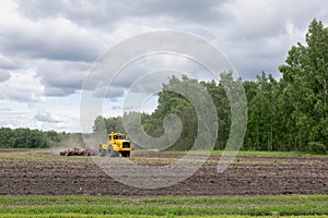 Combine harvester agriculture machine working in field. plows, harrows and cultivates soil for sowing grain