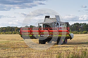 Combine harvester CLAAS works in the field