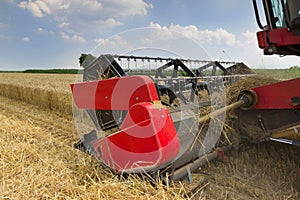 Combine harvester close up. Combine harvester harvesting wheat. Grain harvesting combine. Combine harvesting wheat. Wheat field bl