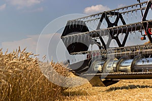 Combine harvester close up. Combine harvester harvesting wheat. Grain harvesting combine. Combine harvesting wheat. Wheat field bl