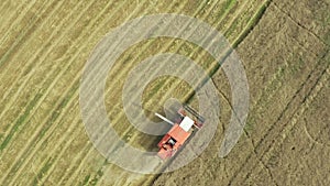 A combine harvester collects a grain harvest from the fields