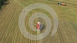 A combine harvester collects a grain harvest from the fields