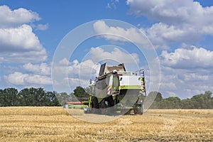 Combine-harvester in the field to gather the harvest of grain crops