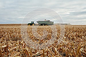 Combine harvester filling a tractor and trailer