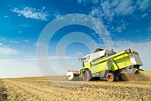 Combine harvester harvesting soybean at field