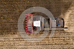 Combine harvester harvesting sunflower field