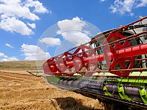 Combine harvester parked in a large Wheat field.