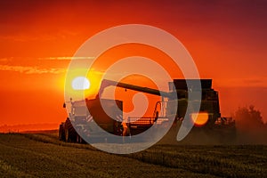 Combine harvester at sunset