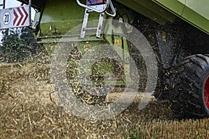 Combine harvester throwing corn wastes