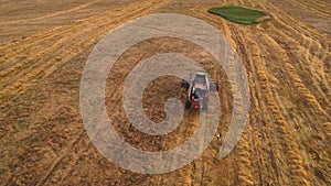 Combine Harvester on Wheat harvesting in field.