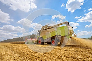 A combine harvester at work on a field.
