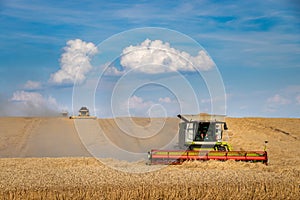 Combine harvester working at agricultural field.