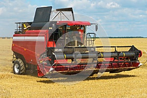 The combine harvester is working in the field. Agro-industrial complex, grain harvest season. Harvesting and harvesting of wheat,