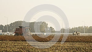 Combine Harvester Working And Harvesting Crops In The Agricultural Fields In Poland. - wide shot