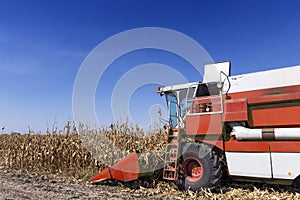 Combine Harvester Working On Maize Field