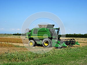 Combine harvesting crop corn grain fields.