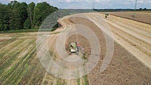 Combine harvesting rapeseed aerial view by drone