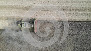 Combine harvesting rapeseed aerial view by drone