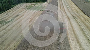 Combine harvesting rapeseed â€“ aerial view by drone