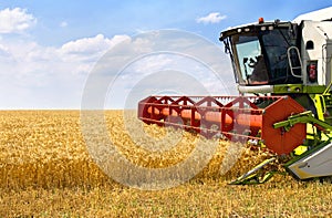 Combine harvesting wheat on of wheat field