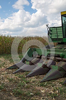 Combine tractor in corn field