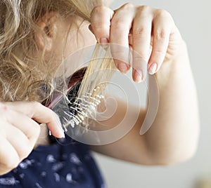 Combing with brush and pulls long hair. Daily preparation for looking nice.