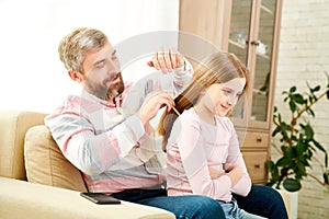 Combing Hair of Little Daughter